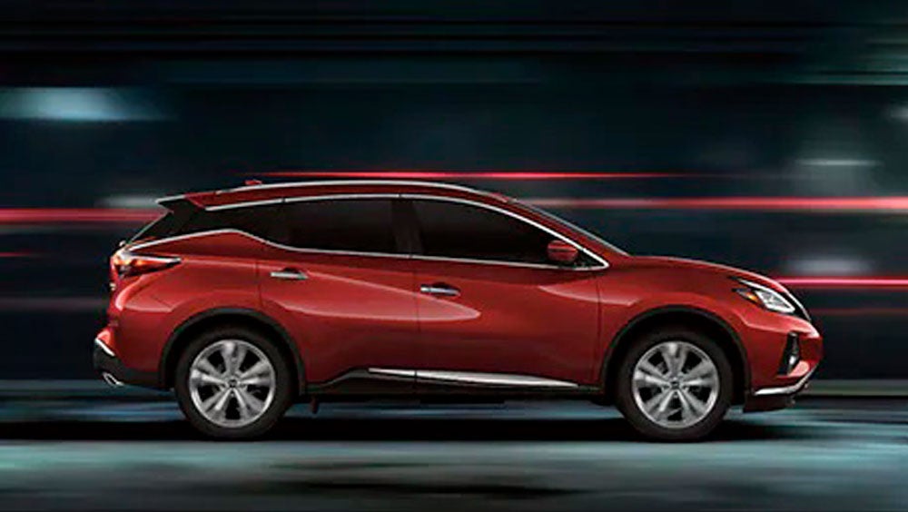 2023 Nissan Murano shown in profile driving down a street at night illustrating performance. | Empire Nissan of Hillside in Hillside NJ