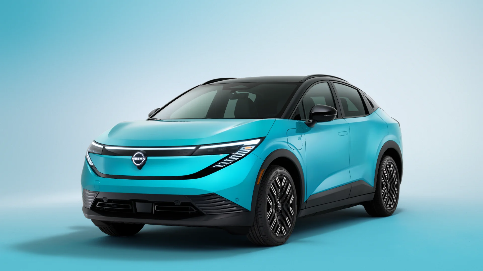 2026 Nissan LEAF® in turquoise shown in front three-quarter with black roof and sleek LED headlamps.