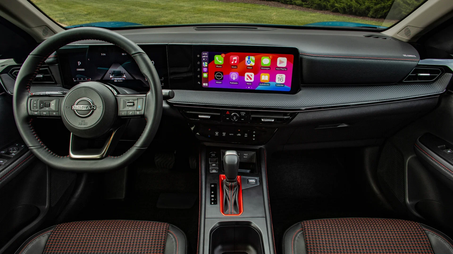 2026 Nissan Kicks® dashboard with steering wheel, digital displays and Apple CarPlay on touchscreen.
