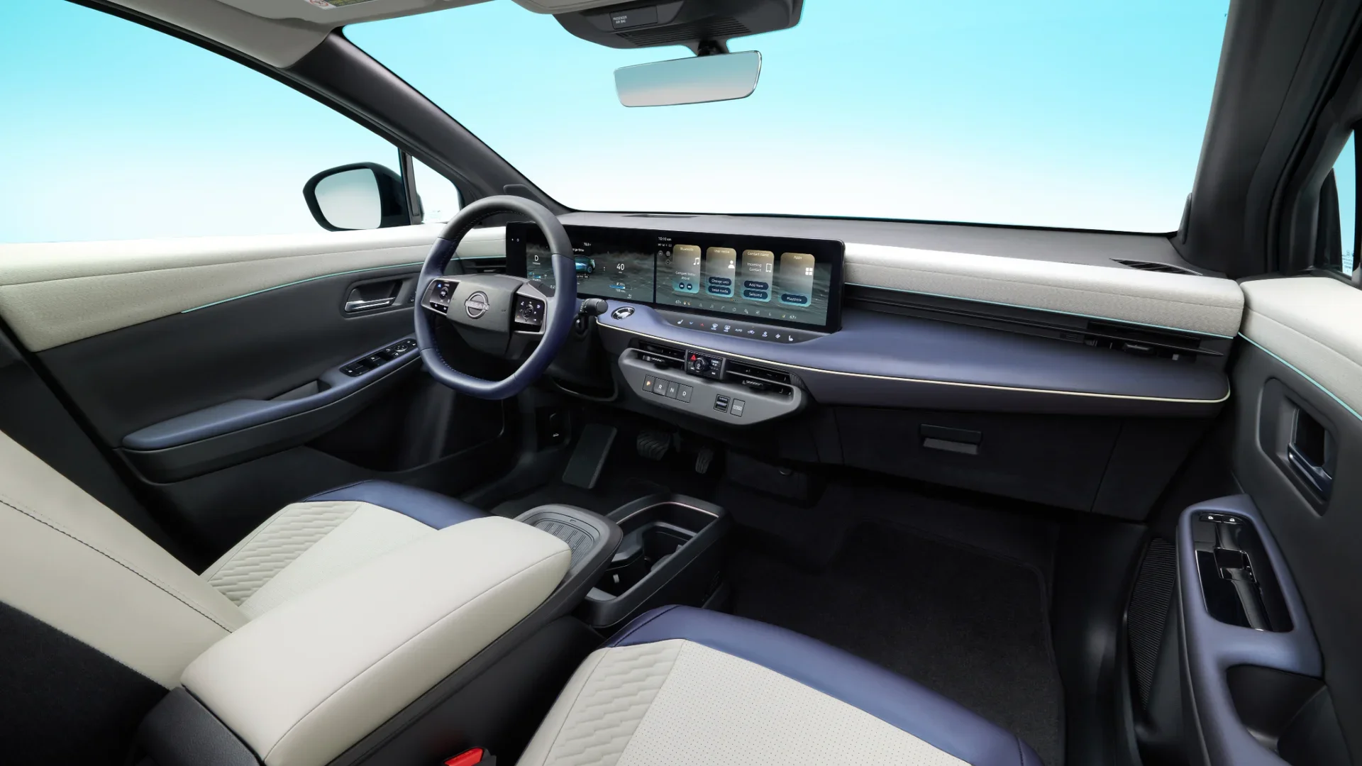 2026 Nissan LEAF® panoramic glass roof viewed from the cabin above light-colored front seating area.